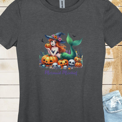 Dark Heather Women's T-shirt with mermaid in witches hat laying in pumpkin patch with text Mermaid Mischief.