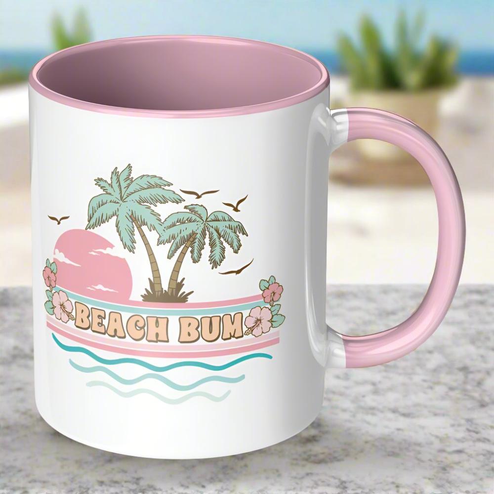 Pink handled mug that says beach bum with a palm tree scene