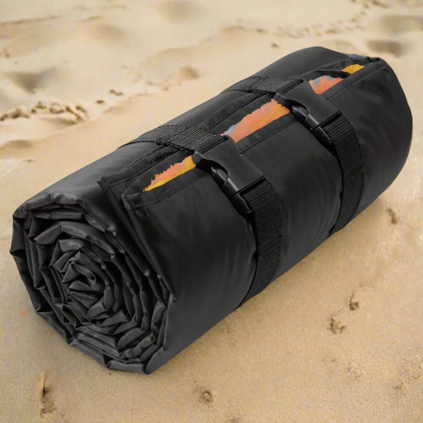 Beach Blanket with waterproof black back rolled up and buckled