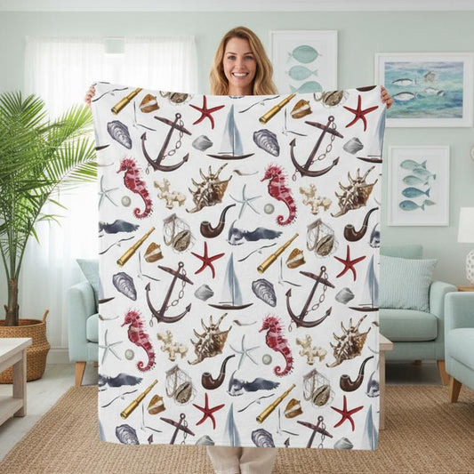 Woman holding a blanket with nautical pattern in a living room