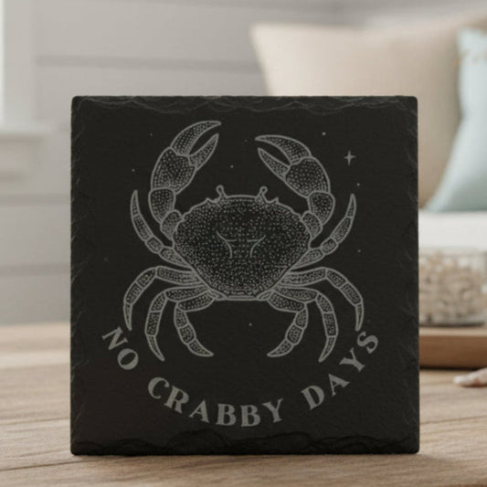 Decorative black slate coaster with crab design and 'No Crabby Days' text.