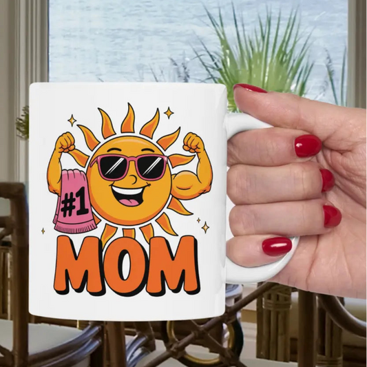 A white 11 oz mug with a muscle woman sun wearing sunglasses holding a beach towel over her arm that says #1 Mom.