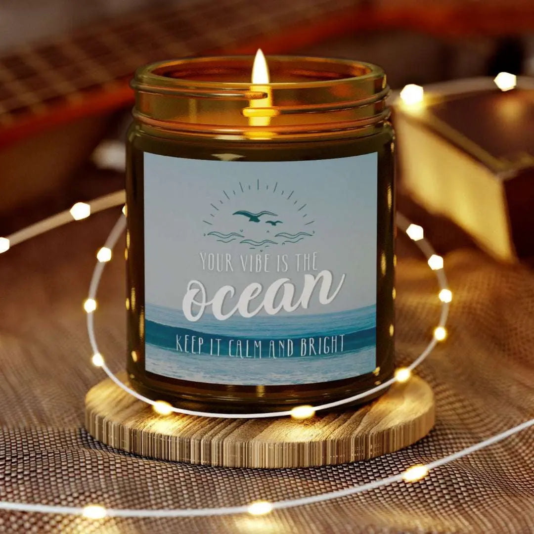 Amber  9 oz Jar Scented candle featuring label with an ocean view with the inspirational phrase 'Your Vibe is the Ocean Keep it Calm and Bright,' making it the perfect addition to any nautical or coastal-themed home decor.