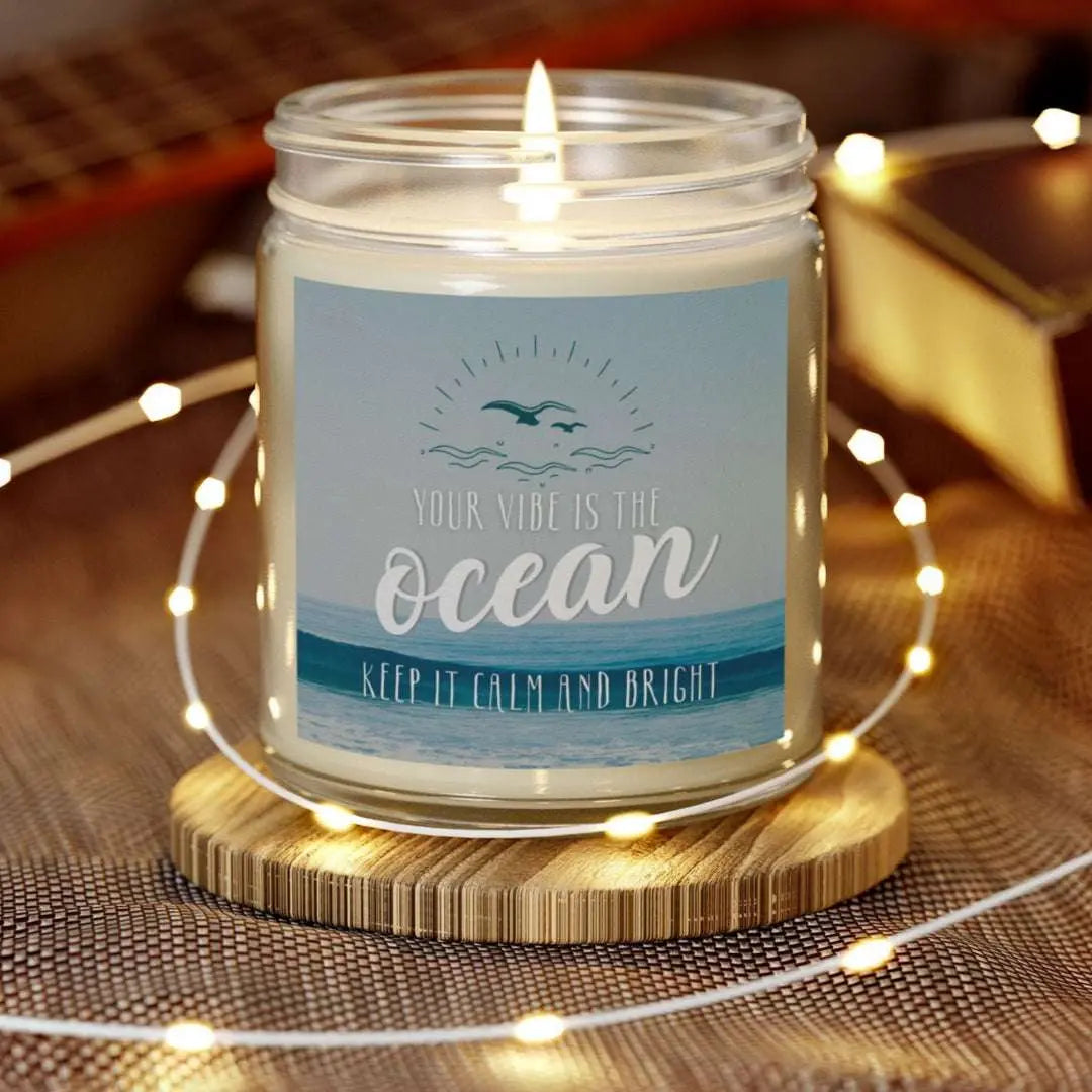 Clear 9 oz Jar scented candle featuring label with an ocean view with the inspirational phrase 'Your Vibe is the Ocean Keep it Calm and Bright,' making it the perfect addition to any nautical or coastal-themed home decor.