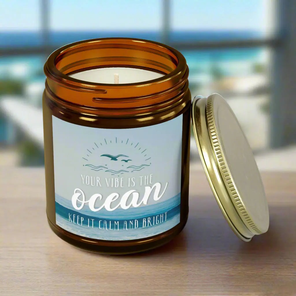 Amber 9 oz Jar scented candle featuring label with an ocean view with the inspirational phrase 'Your Vibe is the Ocean Keep it Calm and Bright,' making it the perfect addition to any nautical or coastal-themed home decor.