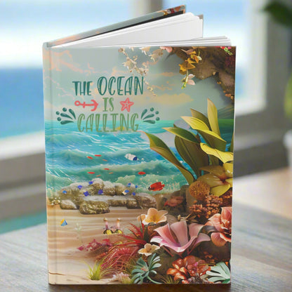 a hardcover journal with ocean and ocean flowers with the text the ocean is calling