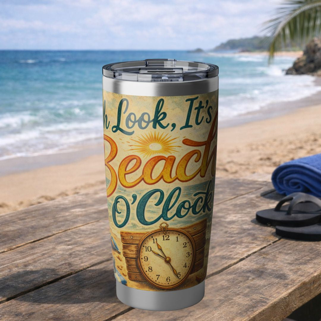 Tumbler with beach-themed design on a wooden table by the ocean.