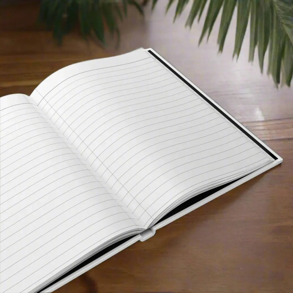 Opened hardcover journal laying open with white lined paper that is perforated for easy removal.