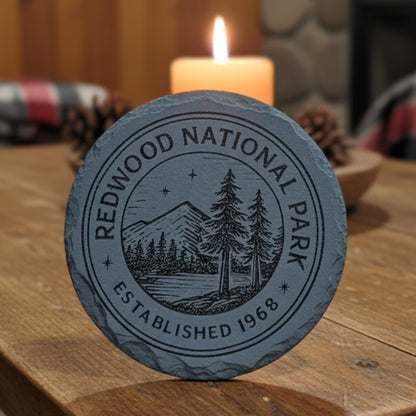 Gray 4" round engraved slate coaster with Redwood National Park patch with scenic design and text.