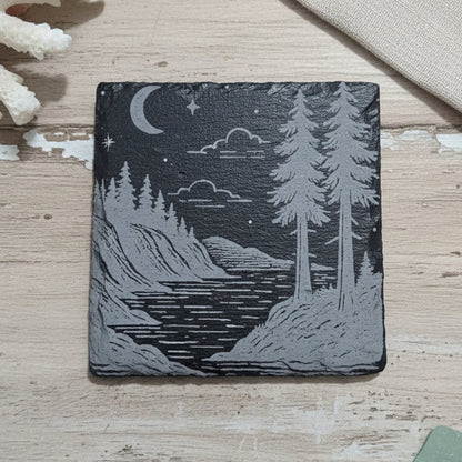 Wooden coaster with a nature design of trees and a river.