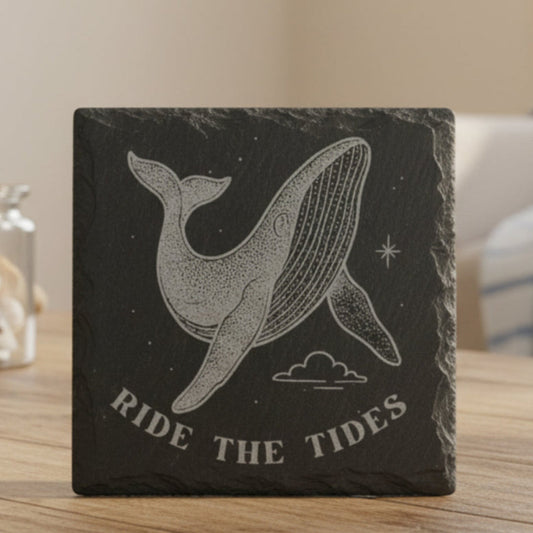 Black slate coaster with whale design and 'Ride the Tides' text engraved.