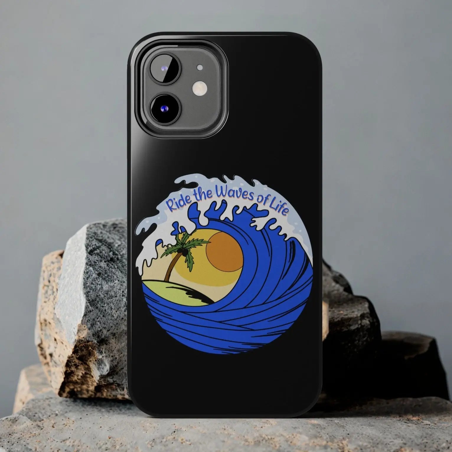 Black iPhone 12 Case with wave with sun and palm tree in the middle that says Ride the Waves of Life.