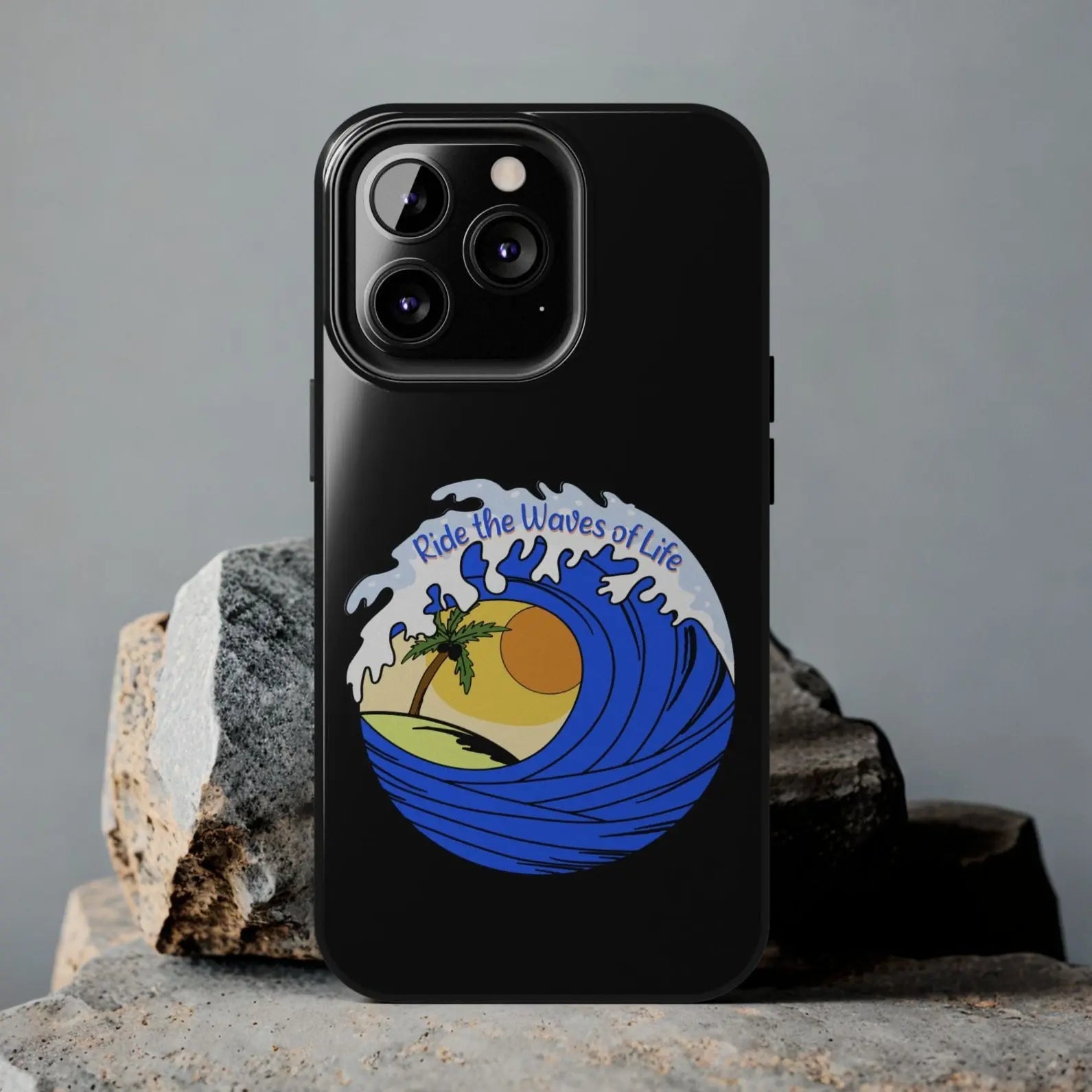 Black iPhone 13 Pro Case with wave with sun and palm tree in the middle that says Ride the Waves of Life.