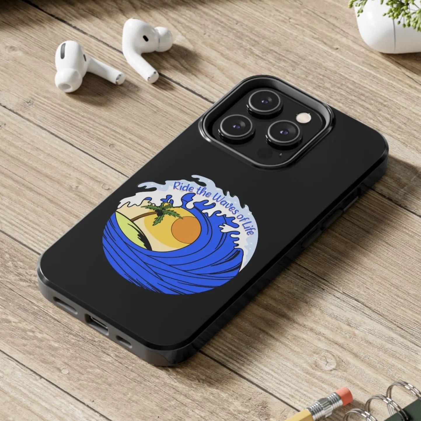 Black iPhone 14 Pro Case with wave with sun and palm tree in the middle that says Ride the Waves of Life.