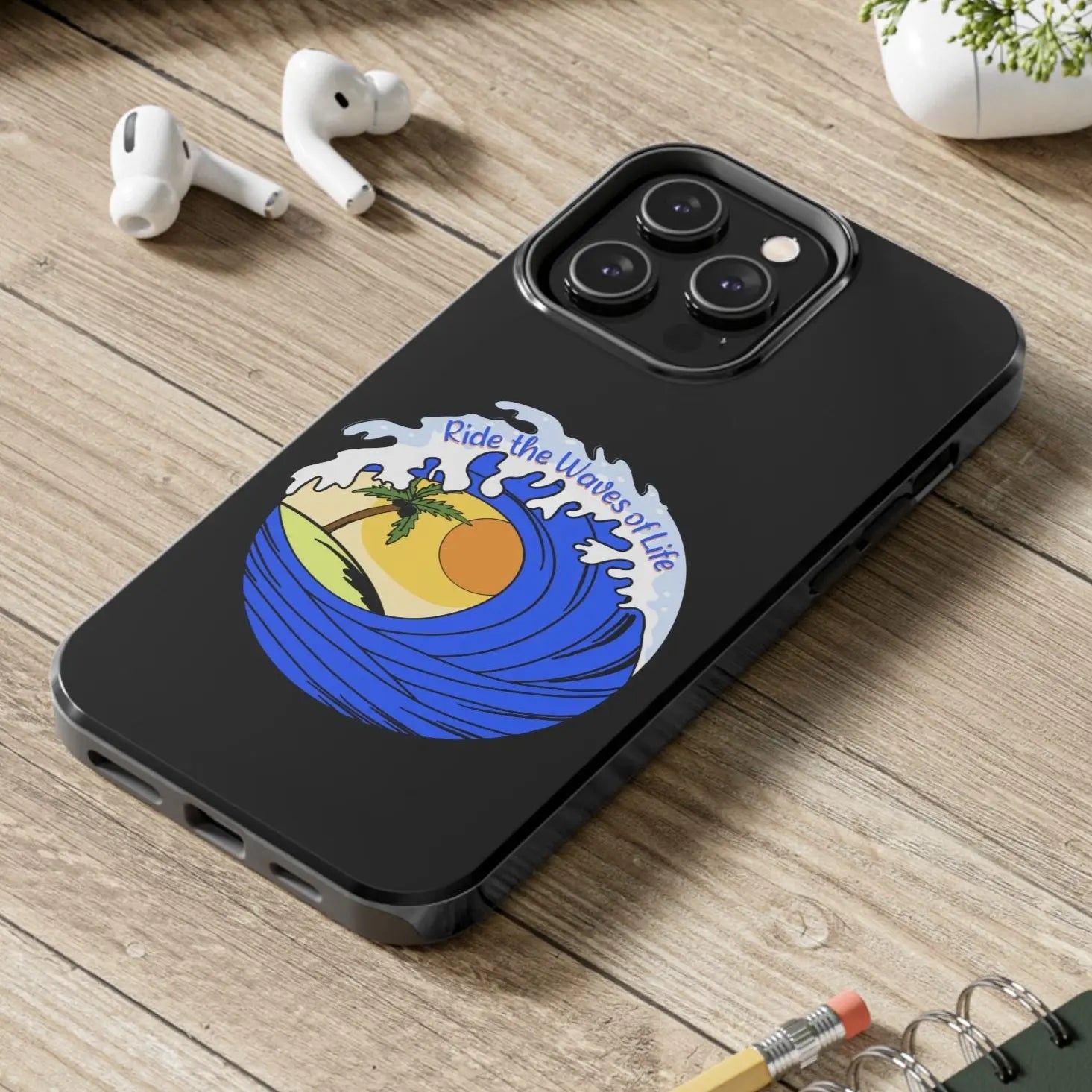 Black iPhone 14 Pro Max Case with wave with sun and palm tree in the middle that says Ride the Waves of Life.