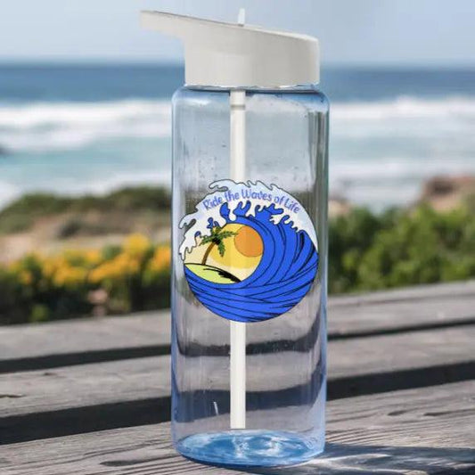 Clear tritan water bottle with ocean wave around sunset with palm tree that says Ride the Waves of Life.
