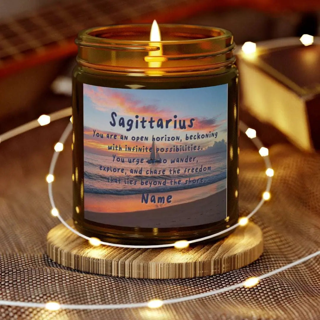 Elegant Sagittarius Zodiac hand-poured coconut apricot wax scented candle in a 9 oz amber glass jar, featuring a picture of the ocean at sunset with a sailboat in the distance and an inspirational quote personalized. A beach-inspired astrology gift, perfect for relaxation and decor.
