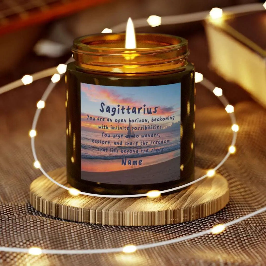 Elegant Sagittarius Zodiac hand-poured coconut apricot wax scented candle in a 4 oz amber glass jar, featuring a picture of the ocean at sunset with a sailboat in the distance and an inspirational quote personalized. A beach-inspired astrology gift, perfect for relaxation and decor.