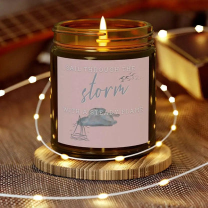 Amber 9 oz Jar Beachwood candle featuring label with a sailboat design and the inspirational phrase 'Sail Through the Storm with a Steady Flame,' making it the perfect addition to any nautical or coastal-themed home decor.