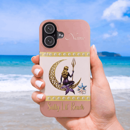 Phone case with mermaid design held by a person on a beach