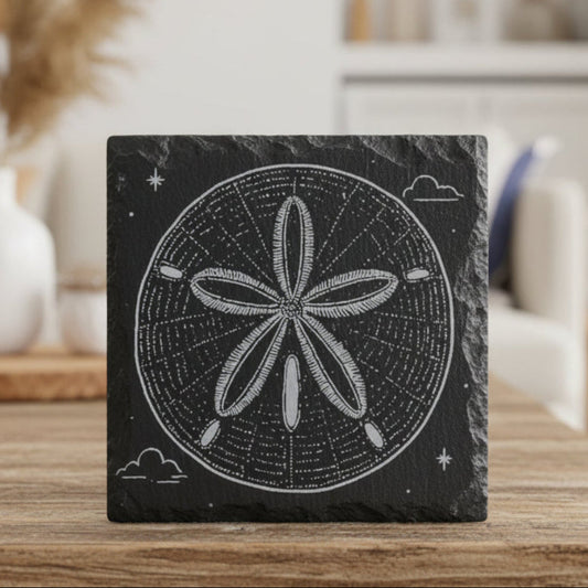 Decorative black slate coaster engraved with sand dollar design.