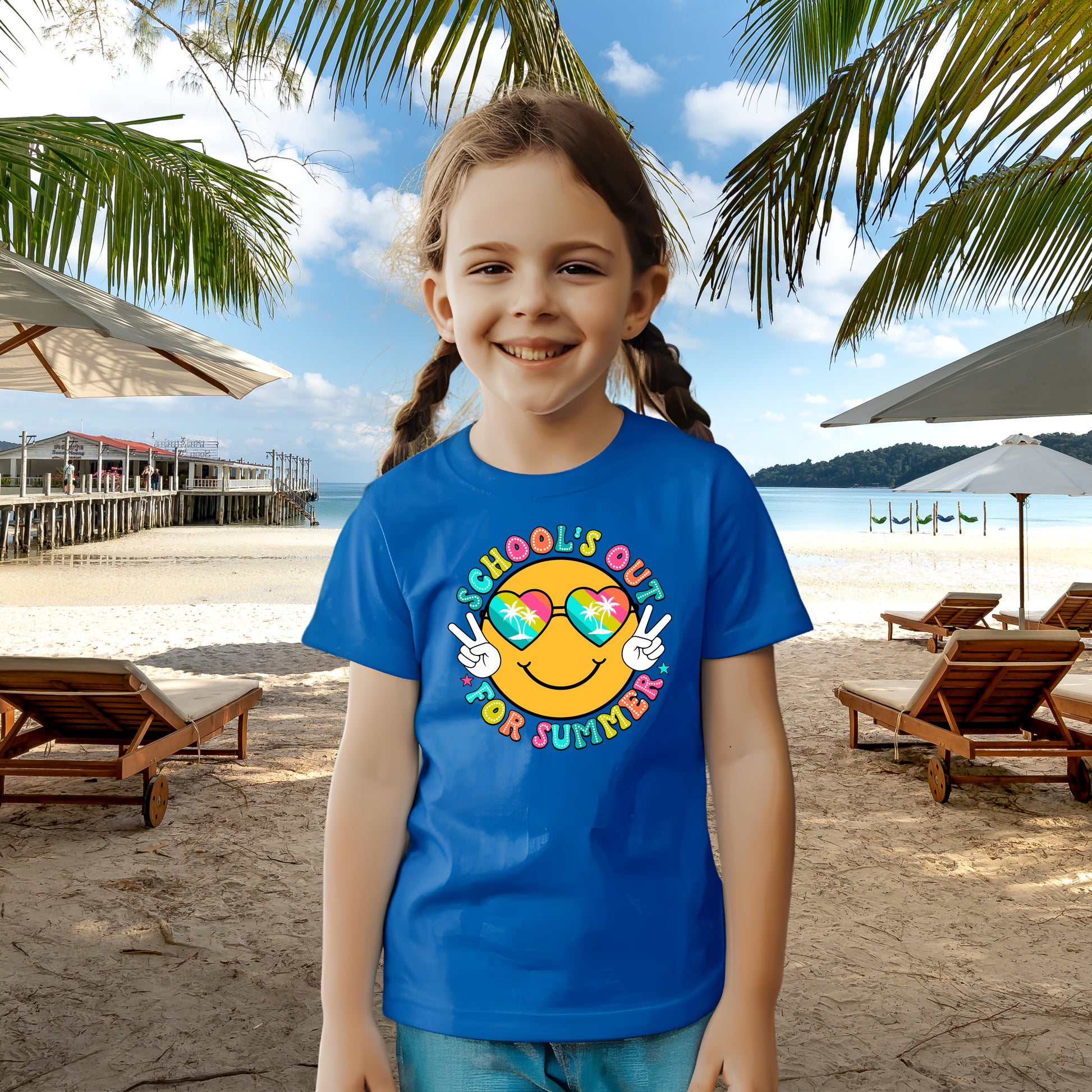 Child in royal blue t-shirt with a beach themed smiley face that says Schools Out for Summer