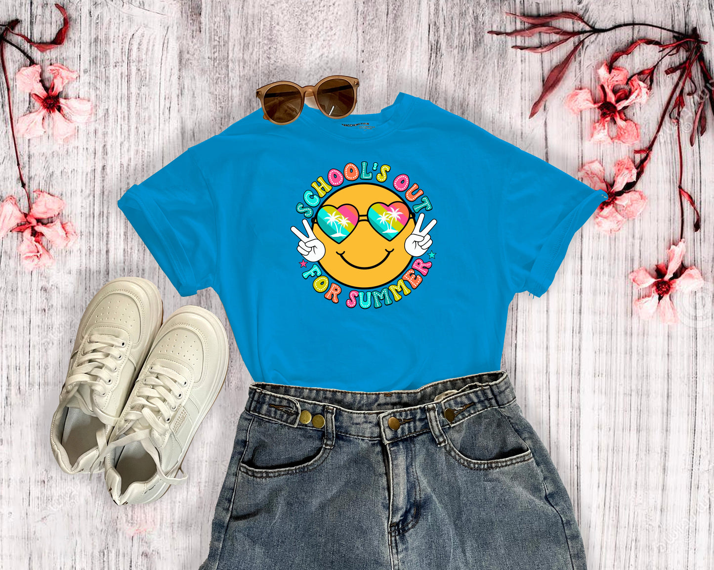 A sapphire colored t-shirt with a beach themed smiley face that says Schools Out for Summer