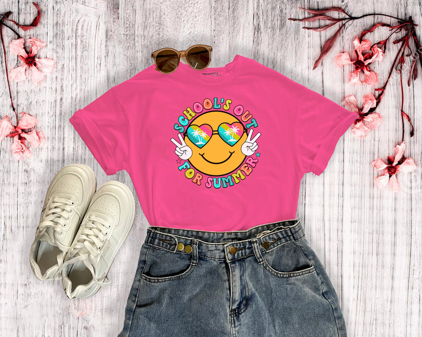 A helicona colored t-shirt with a beach themed smiley face that says Schools Out for Summer