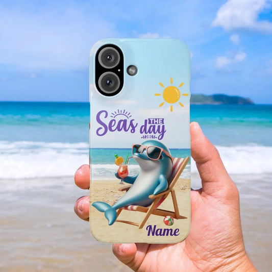 Personalized iPhone 16 Plus case featuring a playful dolphin lounging in a beach chair with a cocktail and the phrase 'Seas the Day.' Customizable with a name, this durable and stylish case is perfect for ocean lovers and beach enthusiasts.
