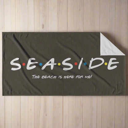 Black beach towel that says Seaside with colored dots in between and says The Beach is Here for Me