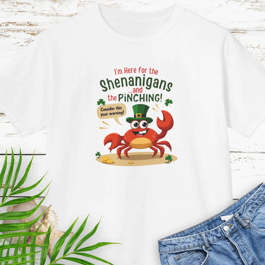 I'm Here for the Shenanigan's and the Pinching White Child T-shirt with a cartoon crab wearing an Irish top hat sitting on the beach holding a sign that says consider this your warning. 