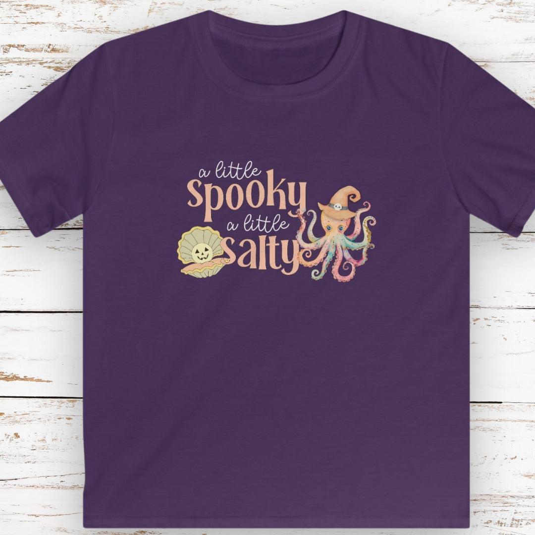 Purple kids t-shirt with pumpkin clam and octopus with witches hat with text that says a little spooky a little salty