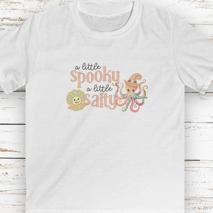 White kids t-shirt with pumpkin clam and octopus with witches hat with text that says a little spooky a little salty