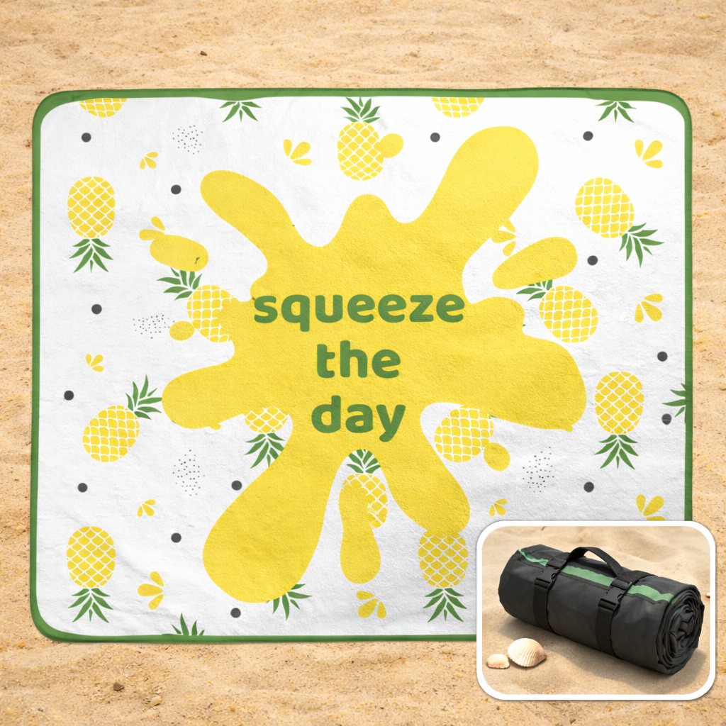 Outdoor beach blanket with yellow splatter design and pineapple pattern, featuring the text 'squeeze the day' with inset of it rolled as a tote bag.