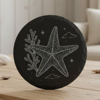 Black stone with a white starfish design engraved.