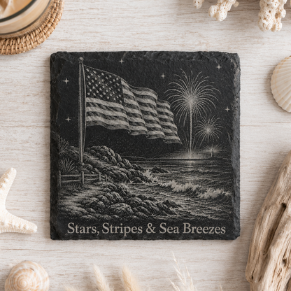 Laser engraved natural slate coaster featuring a patriotic bald eagle, fireworks, lighthouse, and "Land of the Free" with protective padded feet.
