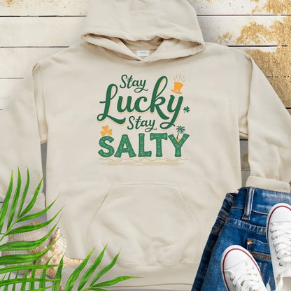 Our Stay Lucky Stay Salty Natural Hoodie with St. Patrick's Day and beach embellishments including shamrock, leprechaun hat, palm tree and ocean waves.