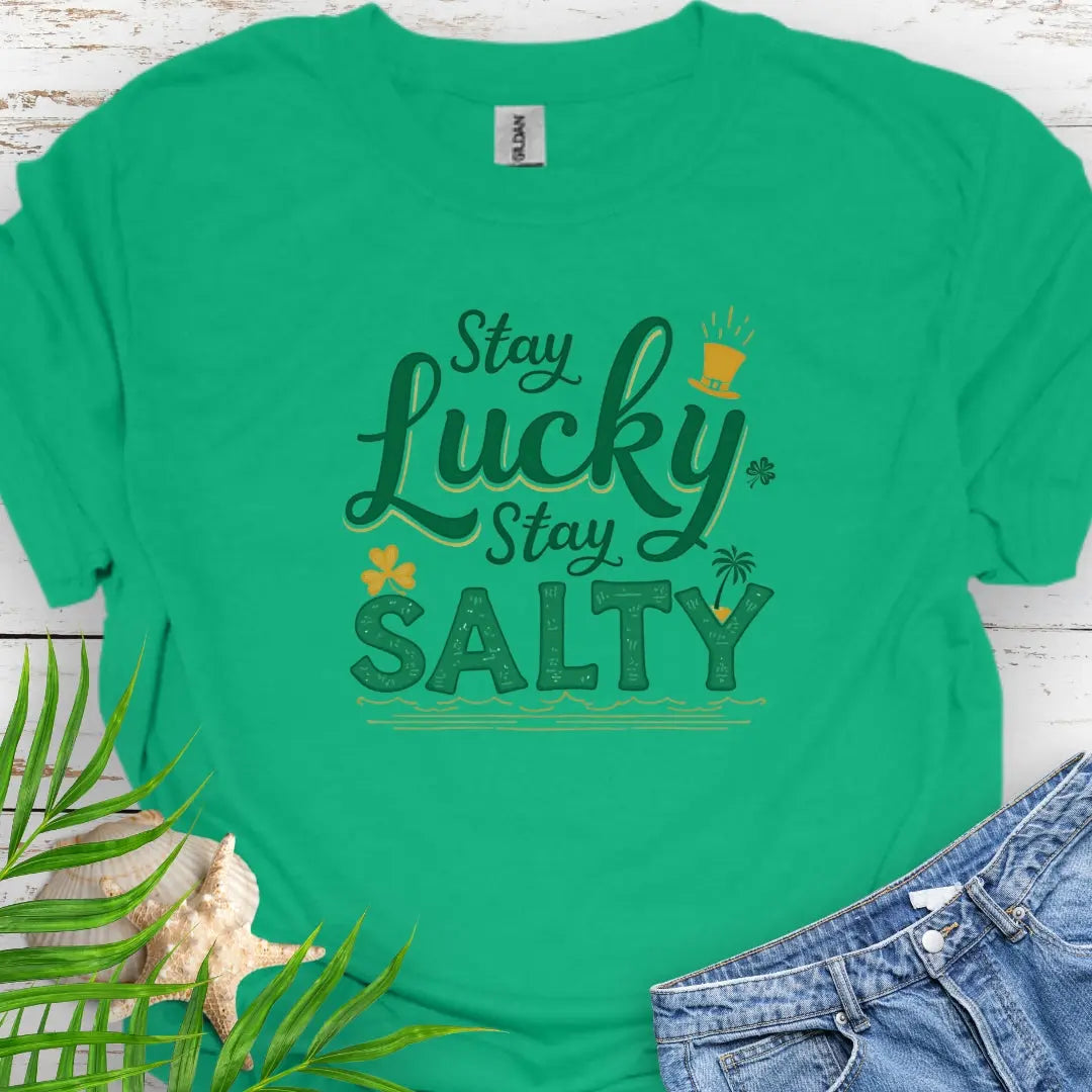 Our Stay Lucky Stay Salty Green T-shirt with St. Patrick's Day and beach embellishments including shamrock, leprechaun hat, palm tree and ocean waves.