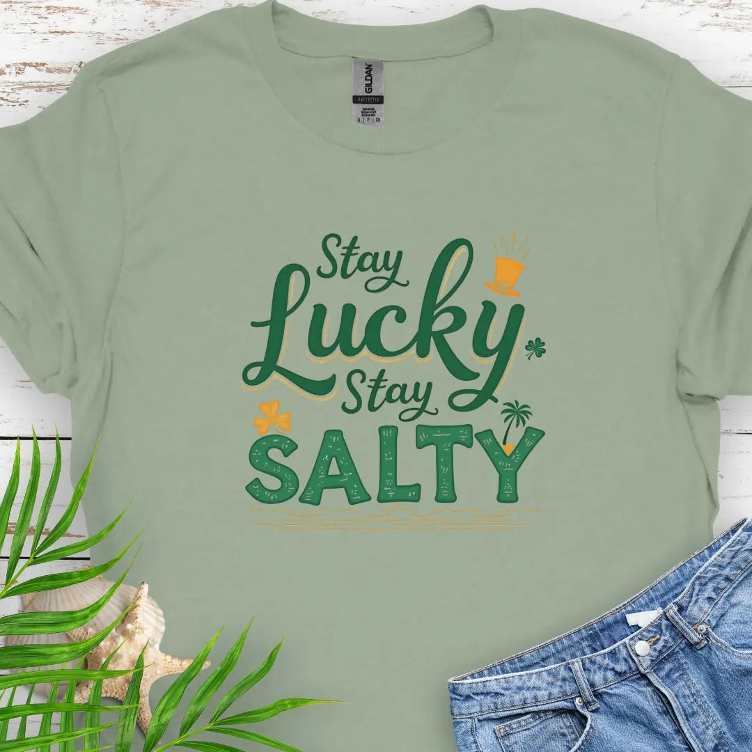 Our Stay Lucky Stay Salty Sage T-shirt with St. Patrick's Day and beach embellishments including shamrock, leprechaun hat, palm tree and ocean waves.