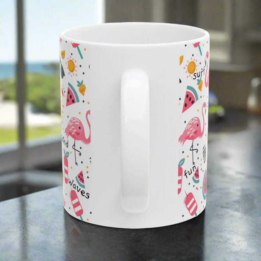 Side view of White beach-themed 11 oz coffee mug with colorful fun designs featuring flamingos, watermelon slices, sun, and popsicles. Perfect summer mug for beach lovers, tropical vibes, and sunny morning coffee.