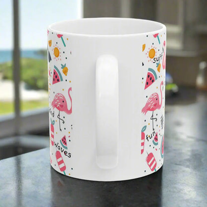 Side view of White beach-themed 11 oz coffee mug with colorful fun designs featuring flamingos, watermelon slices, sun, and popsicles. Perfect summer mug for beach lovers, tropical vibes, and sunny morning coffee.