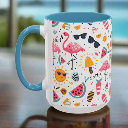 White beach-themed 15 oz coffee mug with blue inside and handle with colorful fun designs featuring flamingos, watermelon slices, sun, and popsicles. Perfect summer mug for beach lovers, tropical vibes, and sunny morning coffee.