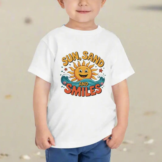A child wearing a White Toddler T-shirt with a smiling sun and waves that says Sun, Sand and Smiles.