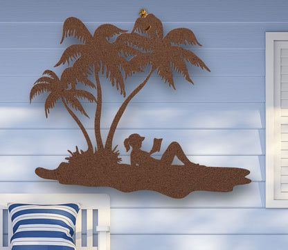 Copper Metal wall art of a woman reading under palm trees on the beach, sunbathing in a tropical scene, crafted from steel and available in multiple sizes and colors.