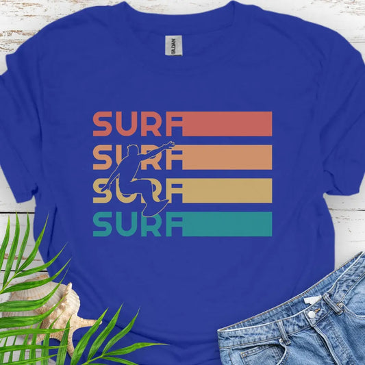 Royal T-shirt with silhouette of surfer over four rows that says surf in rainbow colors and extend out in rectangle. Perfect for surfing enthusiasts.