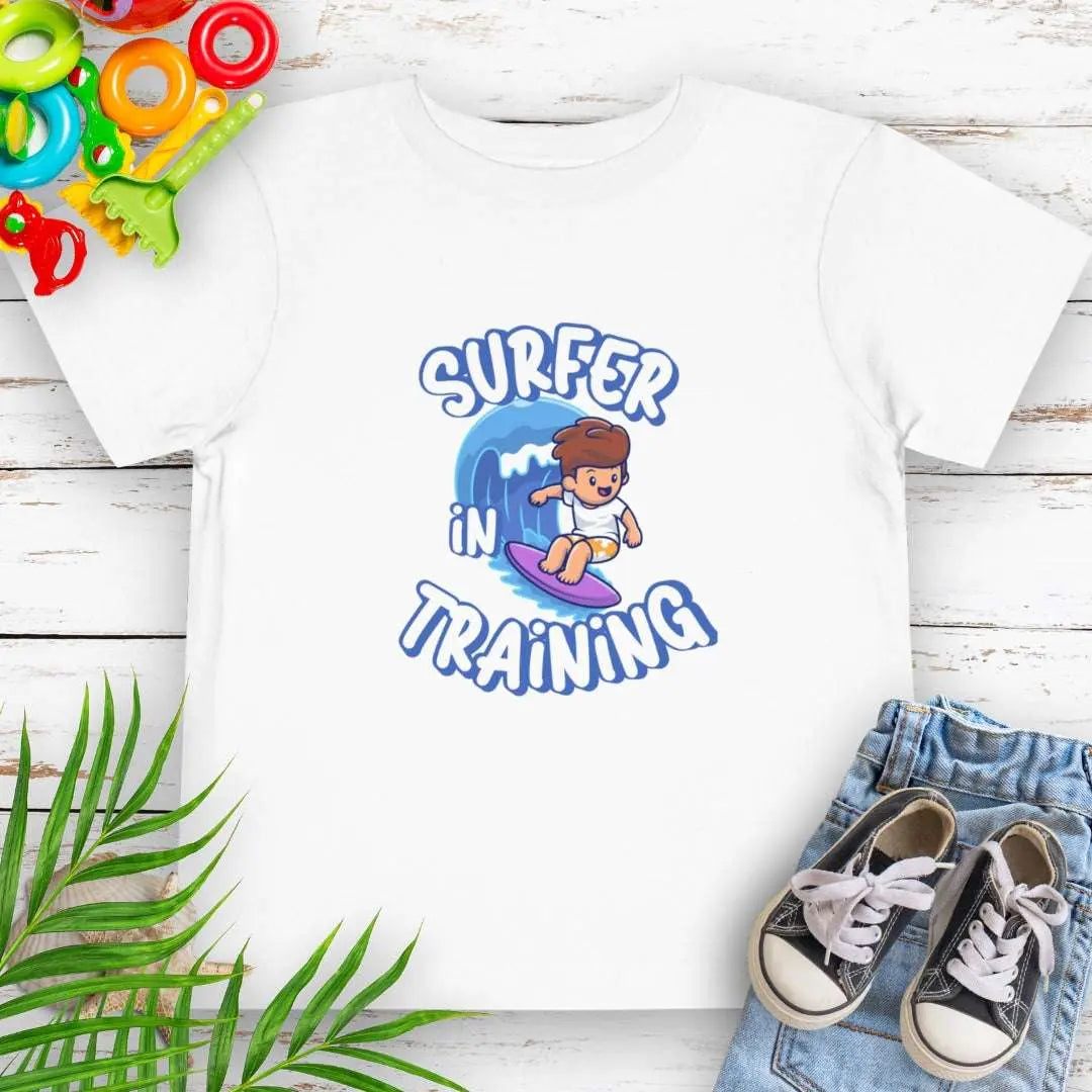 Surfer in Training Toddler's White T-shirt featuring a child surfing.