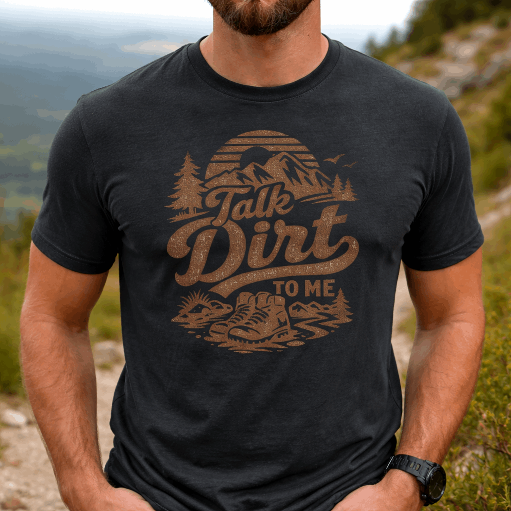 Person wearing a black t-shirt with 'Talk Dirt To Me' graphic design outdoors.