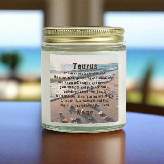 Elegant Taurus Zodiac hand-poured coconut apricot wax scented candle in a 9 oz clear glass jar with gold lid, featuring a scene of the beach with seashells and an inspirational quote personalized. A beach-inspired astrology gift, perfect for relaxation and decor.
