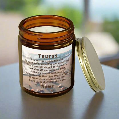 Elegant Taurus Zodiac hand-poured coconut apricot wax scented candle in a 9 oz amber glass jar with gold lid, featuring a scene of the beach with seashells and an inspirational quote personalized. A beach-inspired astrology gift, perfect for relaxation and decor.