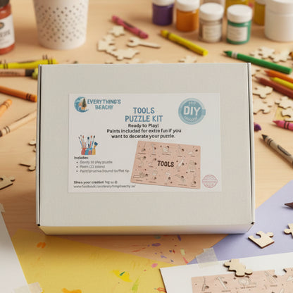 A white box labeled “Tools Puzzle Kit” with a printed card showing puzzle pieces and paint supplies.